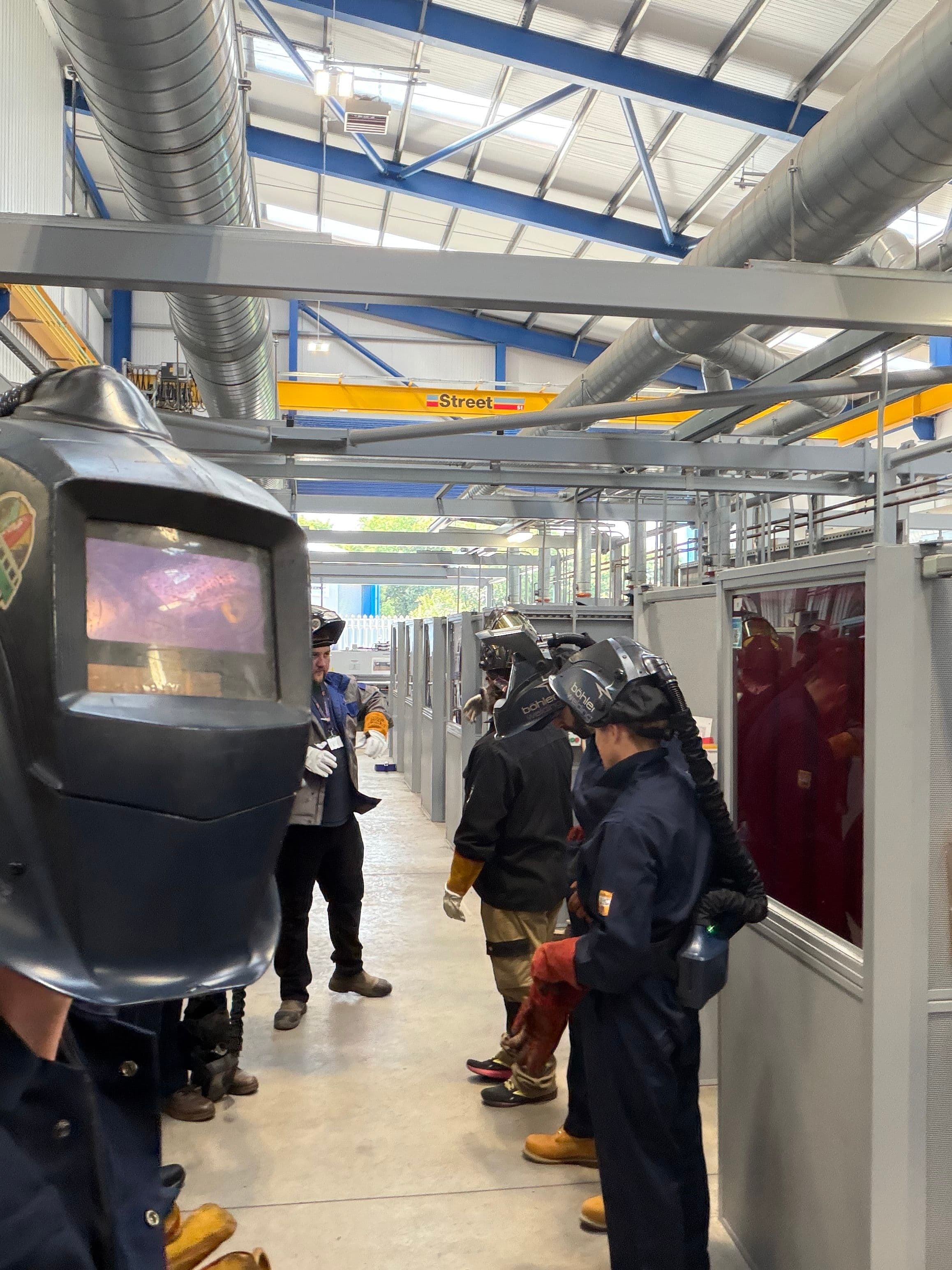 Subco team in welding overalls
