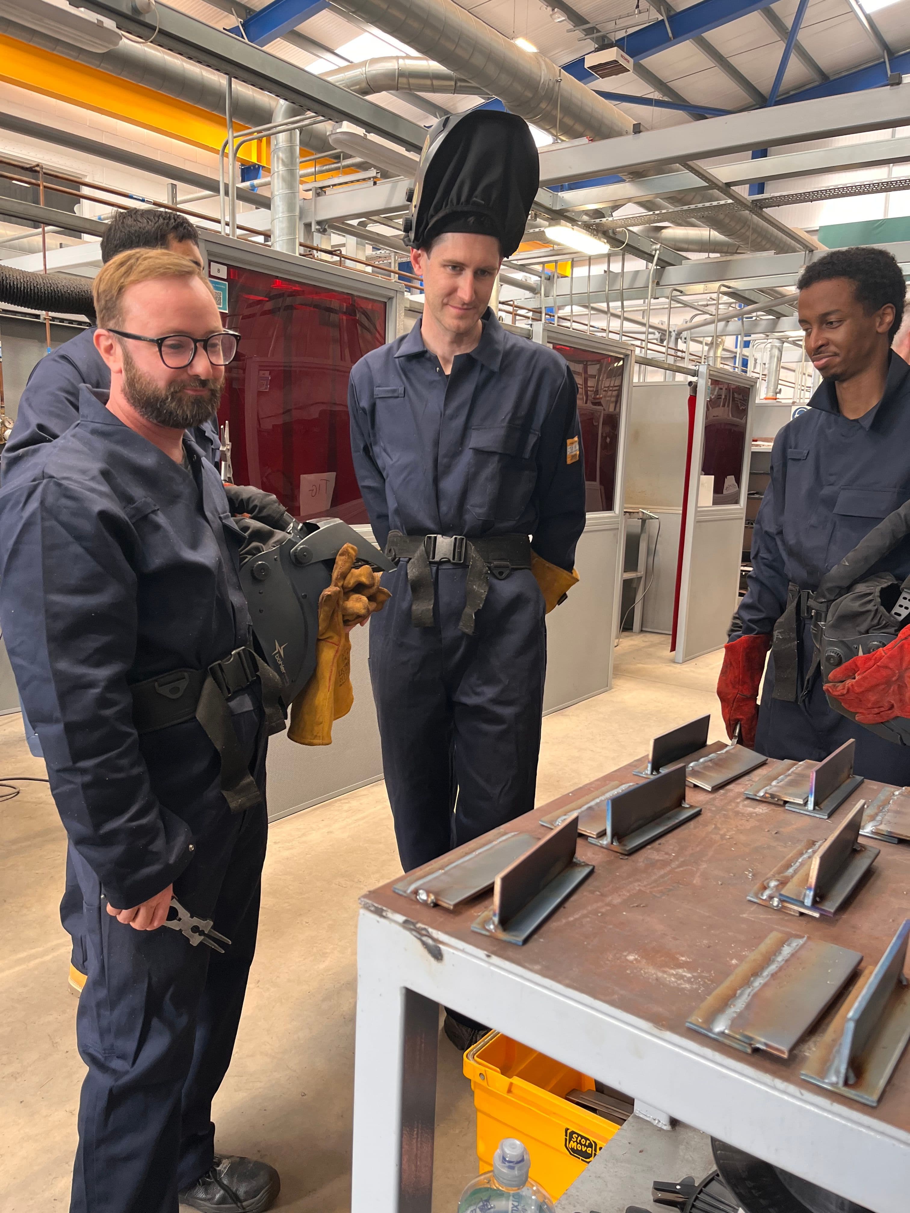 Subco team in welding overalls
